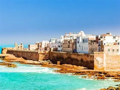 Essaouira ramparts and blue fishing boats at golden hour