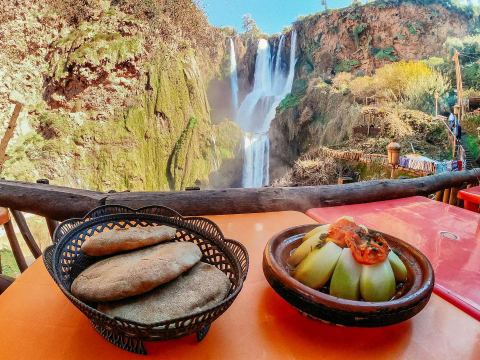A Moroccan tagine meal overlooking Ouzoud waterfalls